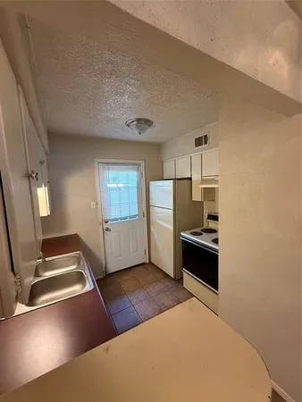 a kitchen with a table chairs and a stove