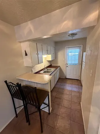 a view of a room with furniture and a chandelier