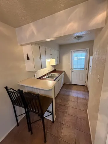a view of a room with furniture and a chandelier