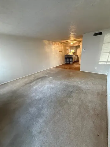 a view of an empty room with windows