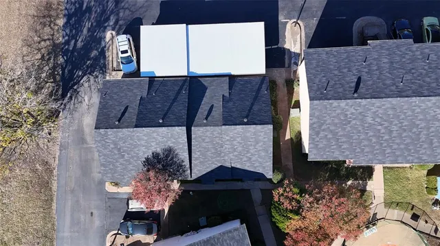 a brick building with a bench and a potted plant