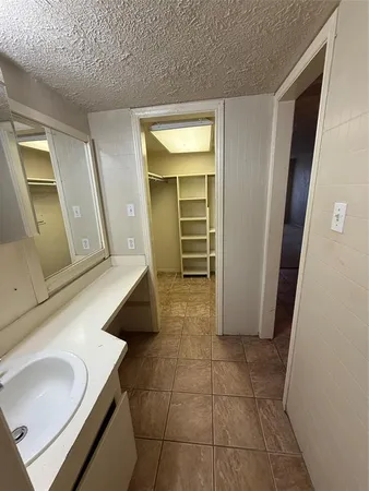a bathroom with a tub a sink and a mirror