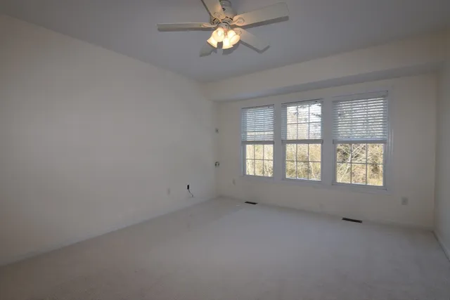 a view of a hallway with wooden staircase