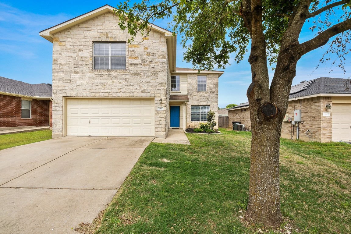 216 Shale Drive Jarrell, TX 76537 - Photo 1 of 1 a front view of a house with a yard and garage