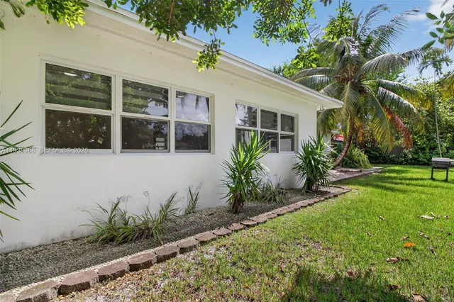 an aerial view of residential houses with outdoor space and swimming pool