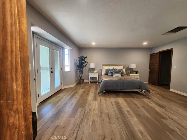 a bedroom with furniture and a wooden floor