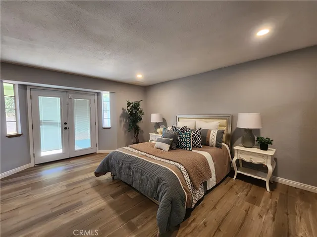 a bedroom with a bed and wooden floor