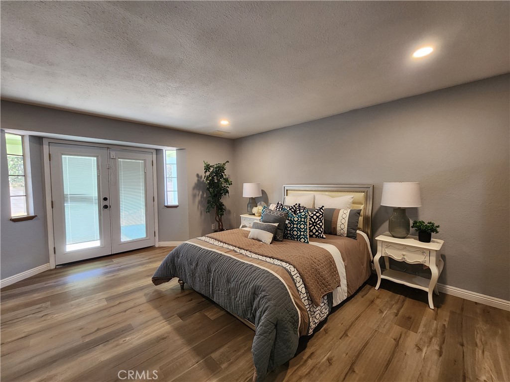 28035 Bonanza Road Barstow, CA 92311 - Photo 14 of 29 a bedroom with a bed and wooden floor