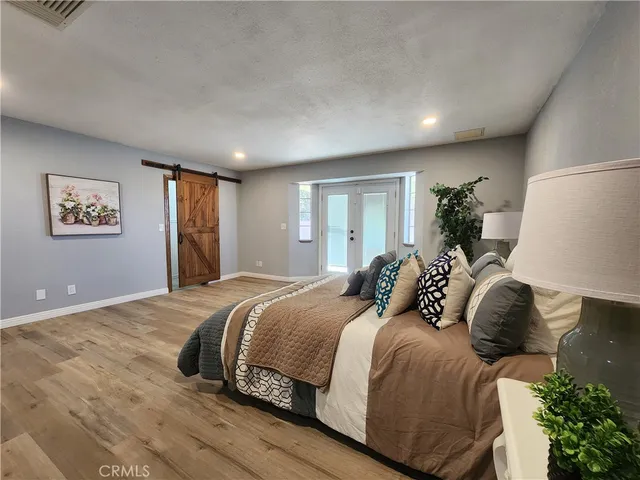 a bedroom with a large bed and a large window