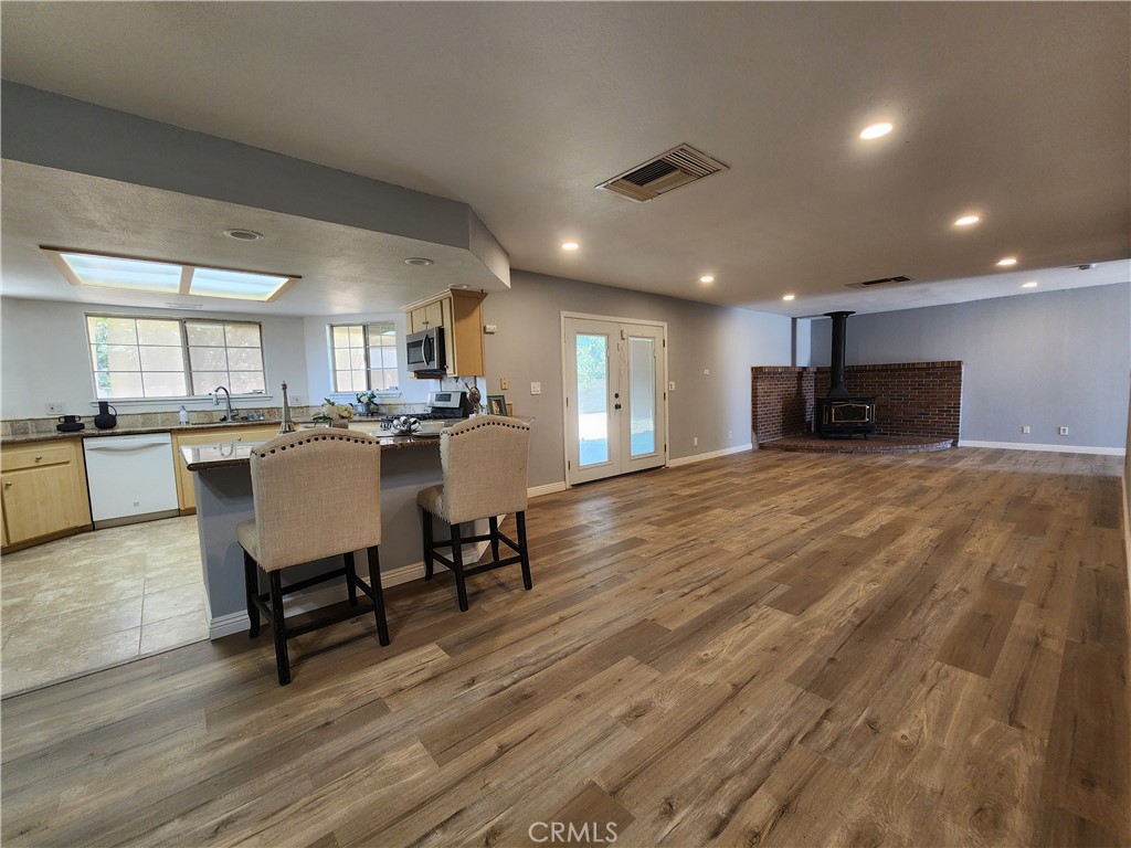 28035 Bonanza Road Barstow, CA 92311 - Photo 19 of 29 a view of a kitchen with kitchen island a dining table chairs and a refrigerator