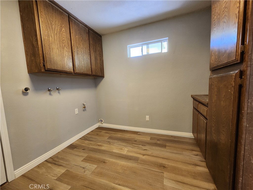 28035 Bonanza Road Barstow, CA 92311 - Photo 22 of 29 a view of an empty room with wooden floor and a window