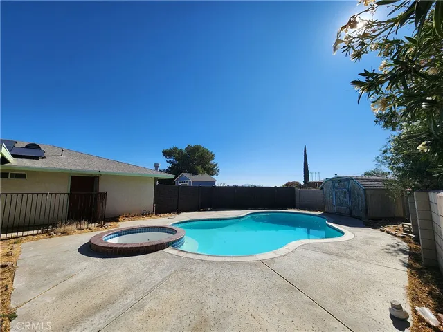 a view of a backyard with a table and chair a barbeque