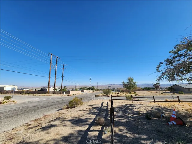 a view of a yard with cars parked on road