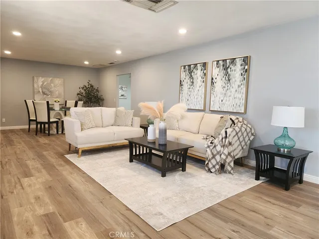a living room with furniture and wooden floor