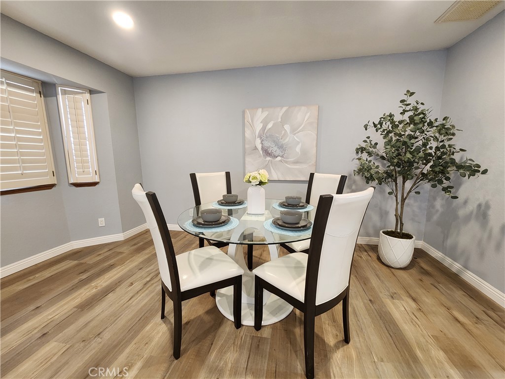 28035 Bonanza Road Barstow, CA 92311 - Photo 8 of 29 a view of a dining room with furniture and wooden floor