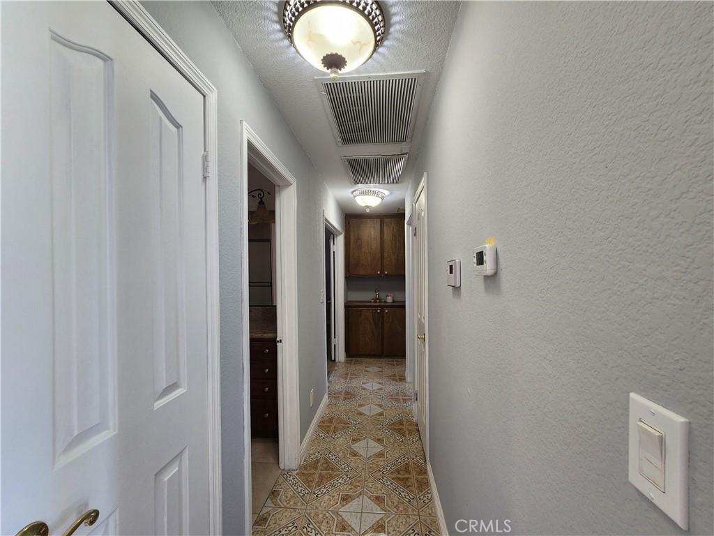 28035 Bonanza Road Barstow, CA 92311 - Photo 10 of 29 a view of a hallway with wooden floor