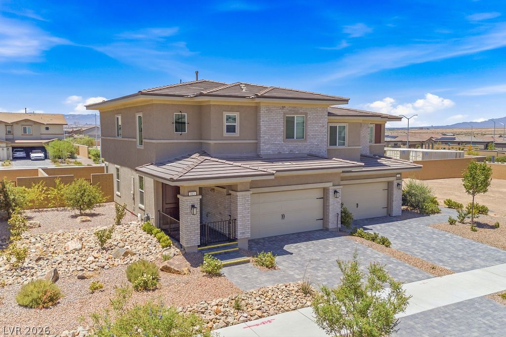 913 Cadence View Way Henderson, NV 89011 - Photo 1 of 46 A striking contemporary residence featuring a blend of stucco and brick, complete with an attached two-car garage.