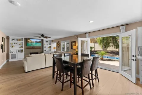 a dining room with furniture and wooden floor