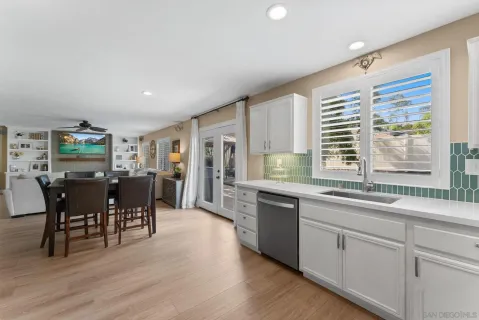 a large kitchen with lots of counter top space and dining table