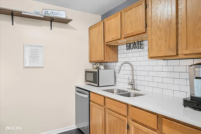 a kitchen with stainless steel appliances granite countertop a sink and a white cabinets