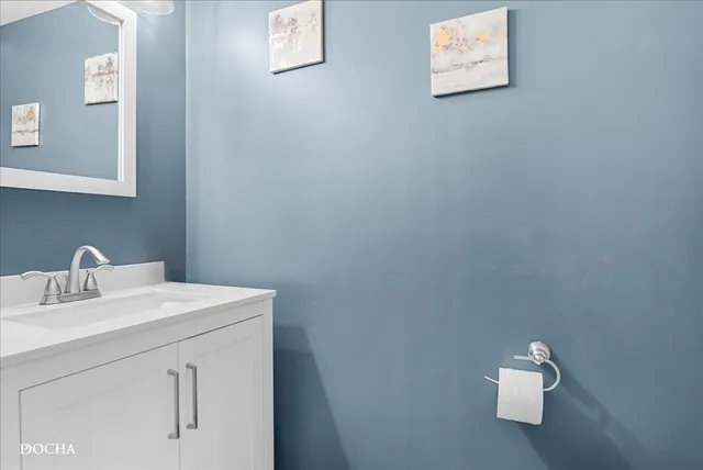 a bathroom with a sink vanity and mirror