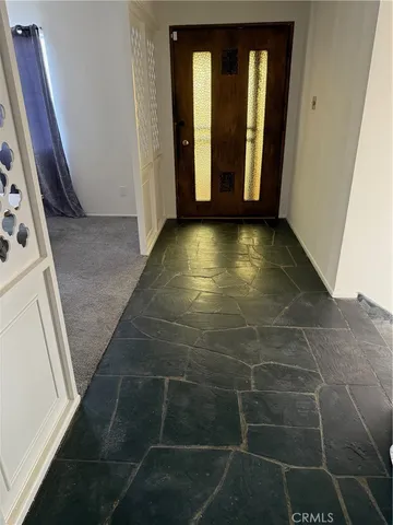 a view of a hallway with wooden floor and stairs