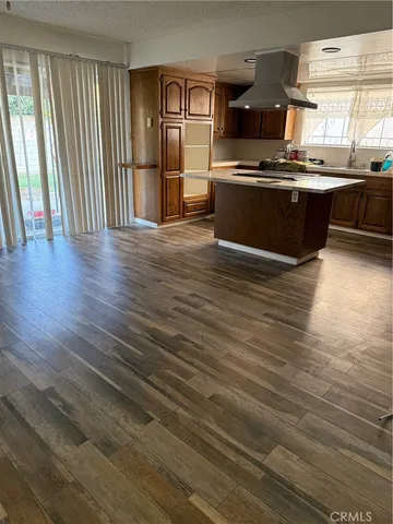 a large kitchen with stainless steel appliances granite countertop a stove a sink and a dishwasher