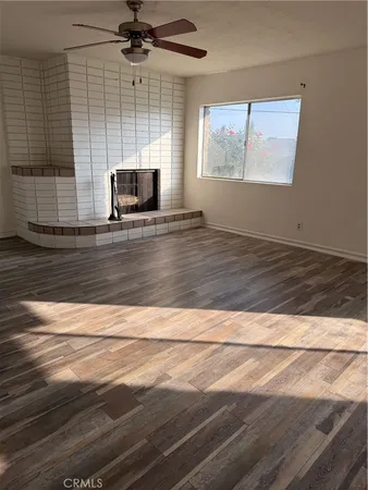 a living room with hard wood floors and a fireplace