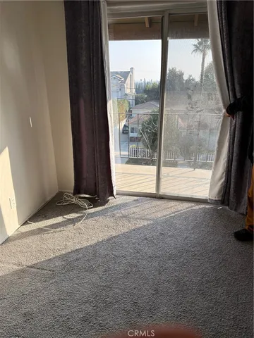a view of a room with wooden floor and a window