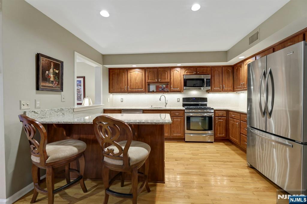 56 Longfellow Lane Mahwah, NJ 07430 - Photo 12 of 33 a kitchen with granite countertop a sink and stainless steel appliances