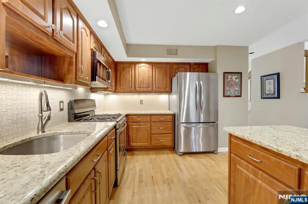 56 Longfellow Lane Mahwah, NJ 07430 - Photo 13 of 33 a kitchen with stainless steel appliances granite countertop a refrigerator stove and sink