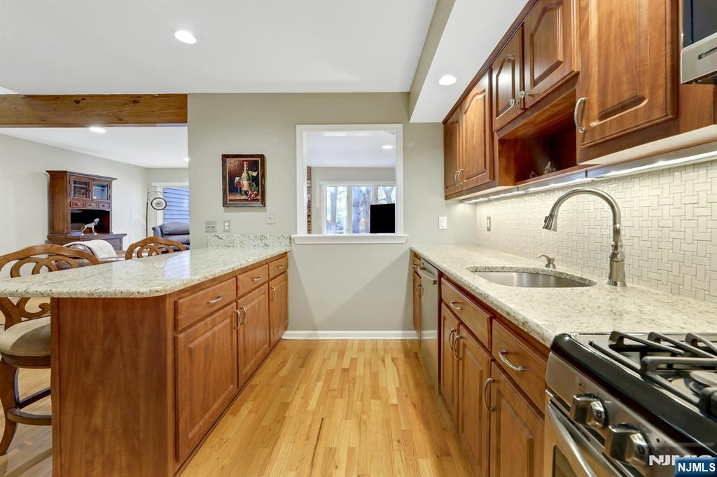 56 Longfellow Lane Mahwah, NJ 07430 - Photo 14 of 33 a kitchen with granite countertop stainless steel appliances and wooden cabinets