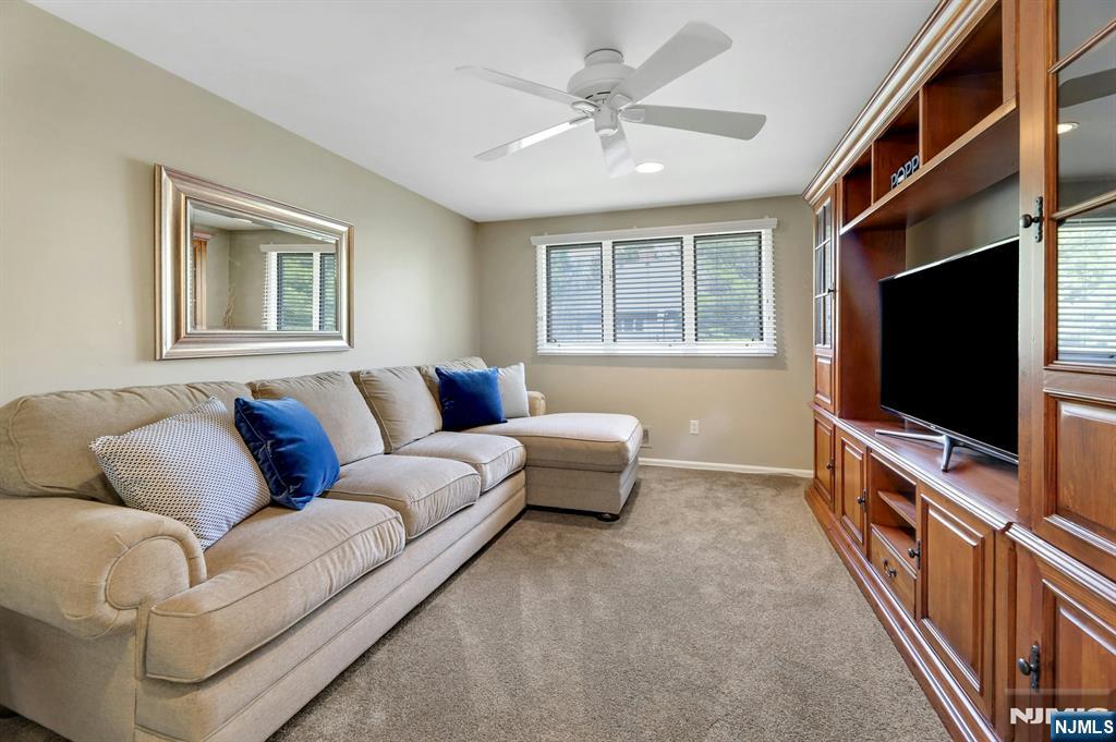 56 Longfellow Lane Mahwah, NJ 07430 - Photo 25 of 33 a living room with furniture and a flat screen tv