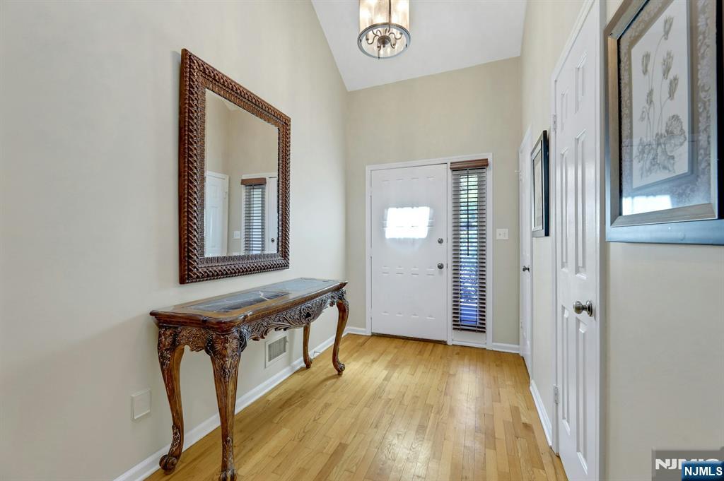 56 Longfellow Lane Mahwah, NJ 07430 - Photo 3 of 33 a view of a hallway with wooden floor and staircase