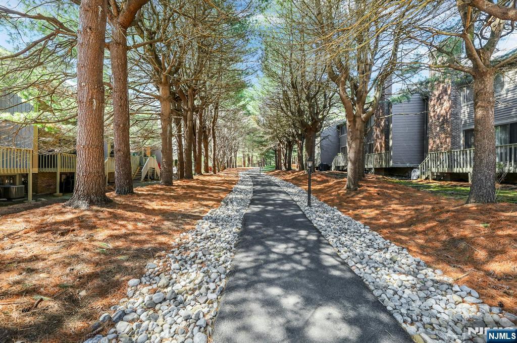 56 Longfellow Lane Mahwah, NJ 07430 - Photo 33 of 33 a backyard of a house with trees and outdoor seating