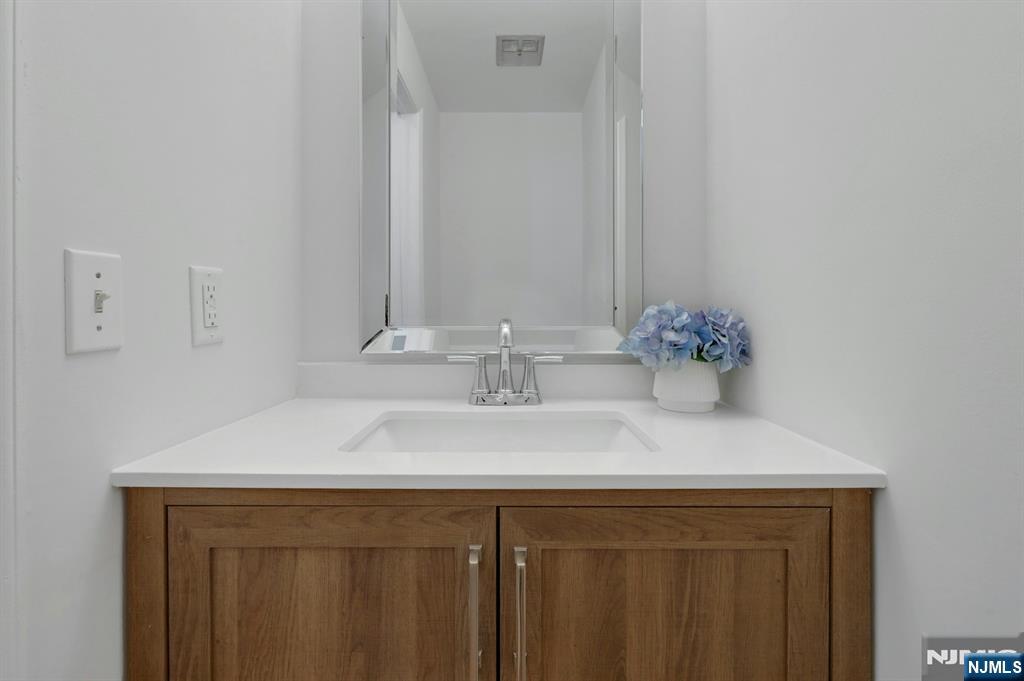 56 Longfellow Lane Mahwah, NJ 07430 - Photo 5 of 33 a bathroom with a sink and a mirror