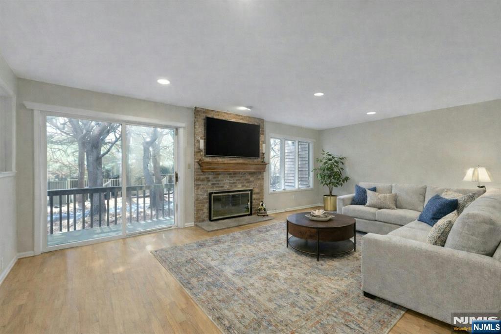56 Longfellow Lane Mahwah, NJ 07430 - Photo 8 of 33 a living room with furniture a fireplace and a flat screen tv