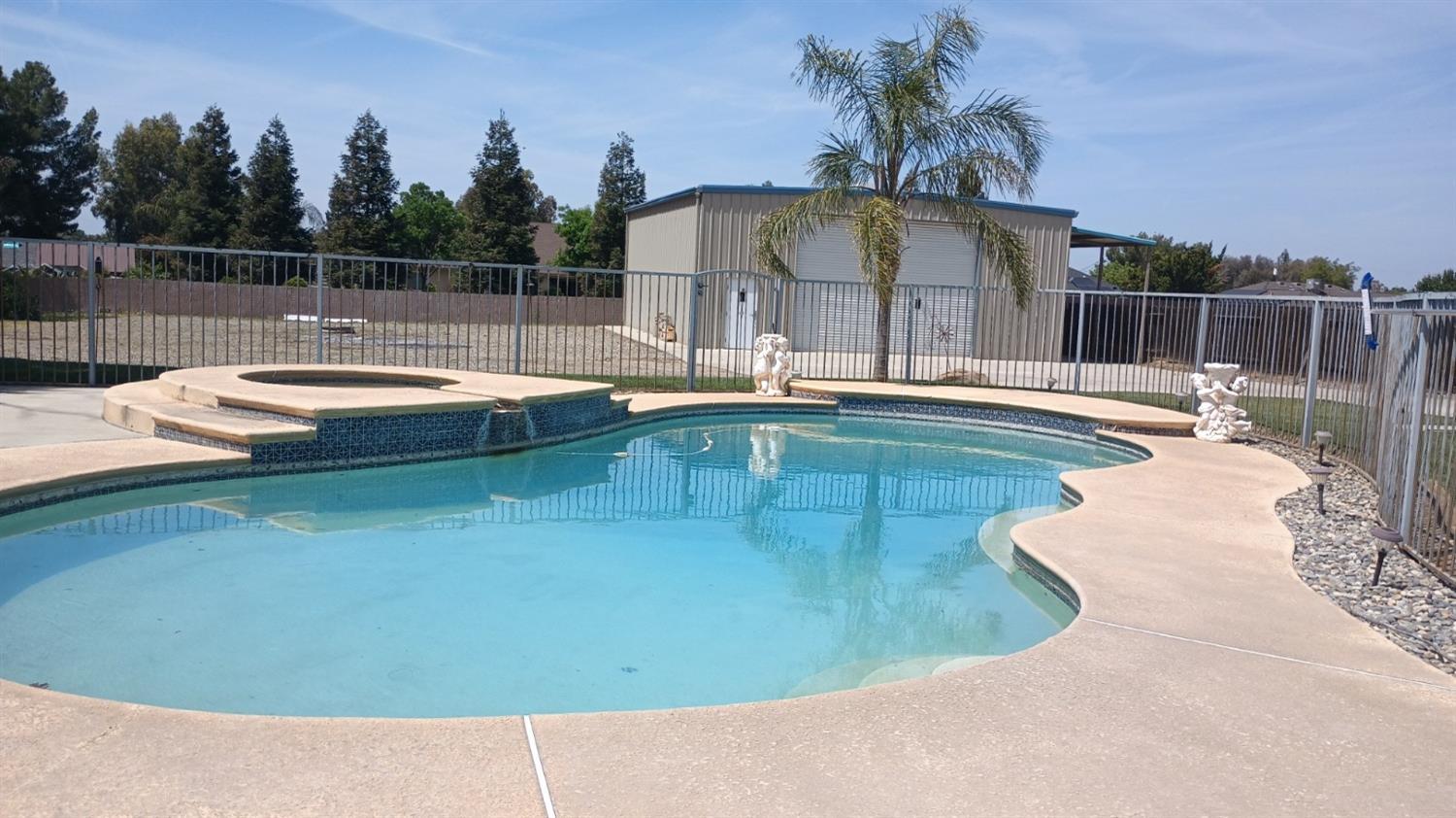 14728 Huntington Road Madera, CA 93636 - Photo 12 of 37 a view of a swimming pool with a yard