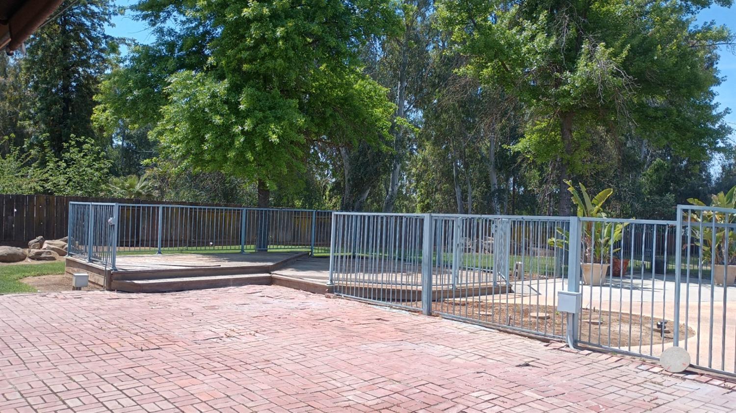 14728 Huntington Road Madera, CA 93636 - Photo 14 of 37 a small garden with large trees