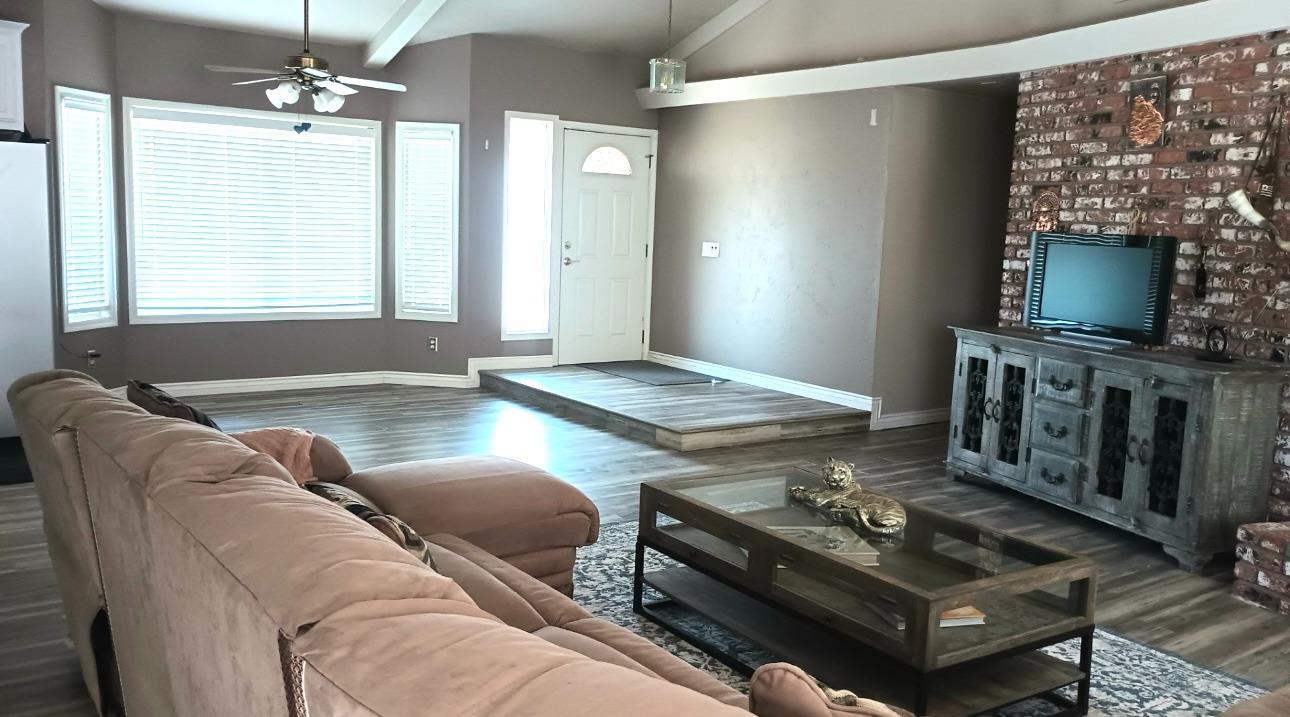 14728 Huntington Road Madera, CA 93636 - Photo 19 of 37 a living room with furniture and a fireplace