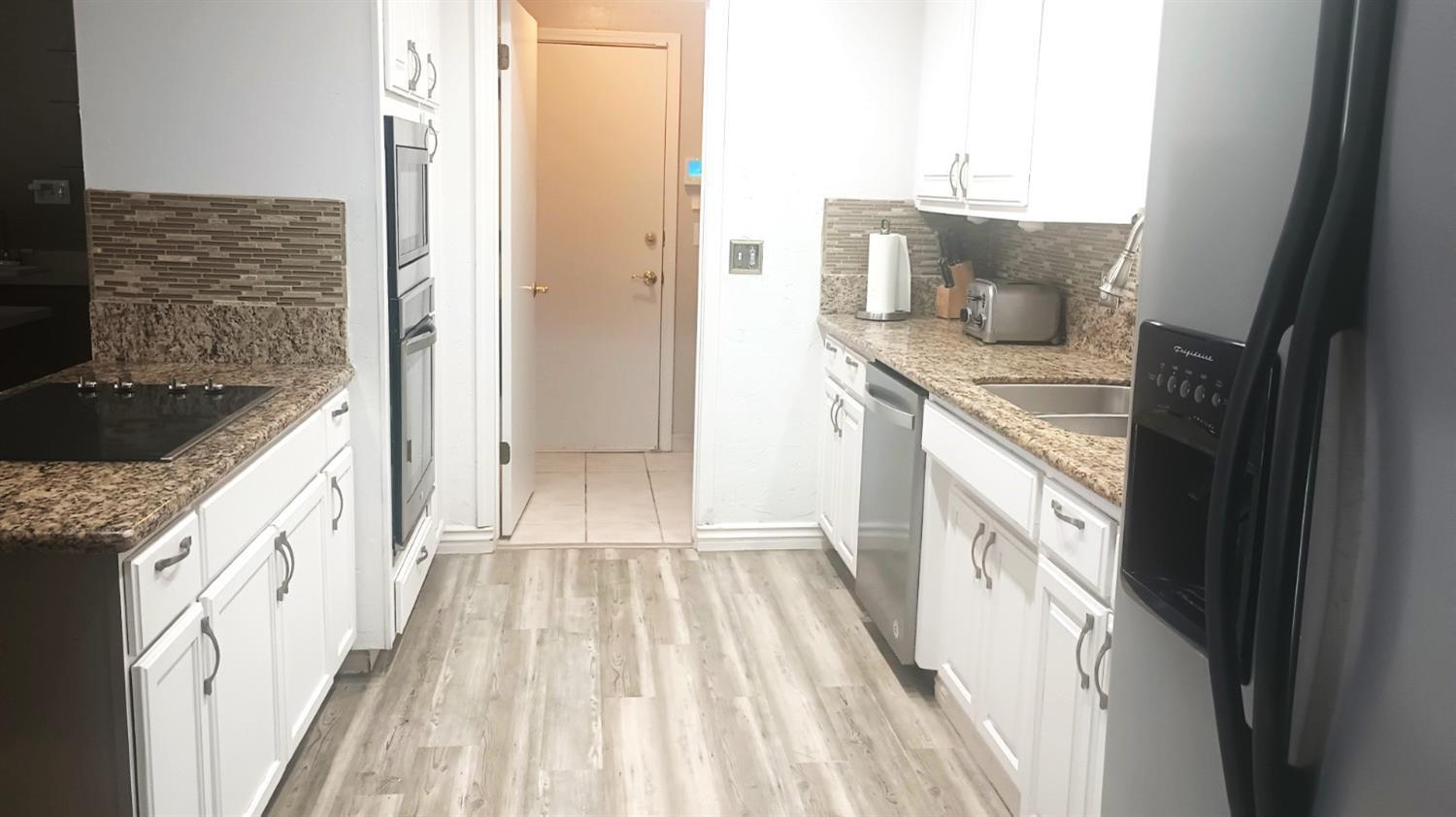 14728 Huntington Road Madera, CA 93636 - Photo 29 of 37 a bathroom with a granite countertop sink and a mirror