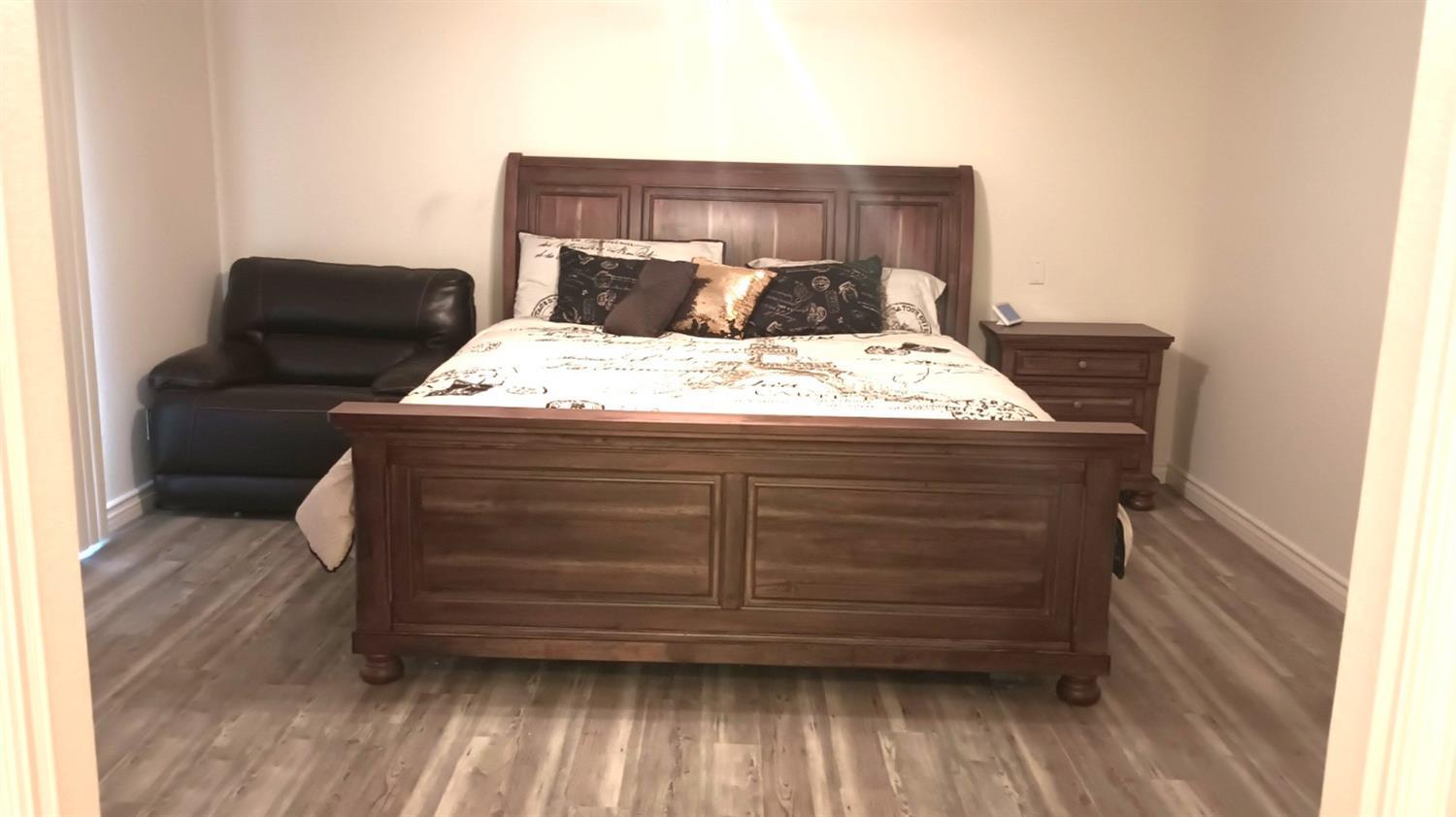 14728 Huntington Road Madera, CA 93636 - Photo 31 of 37 a bedroom with a bed and wooden floor