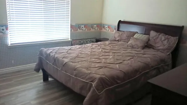 a bedroom with a bed and a television