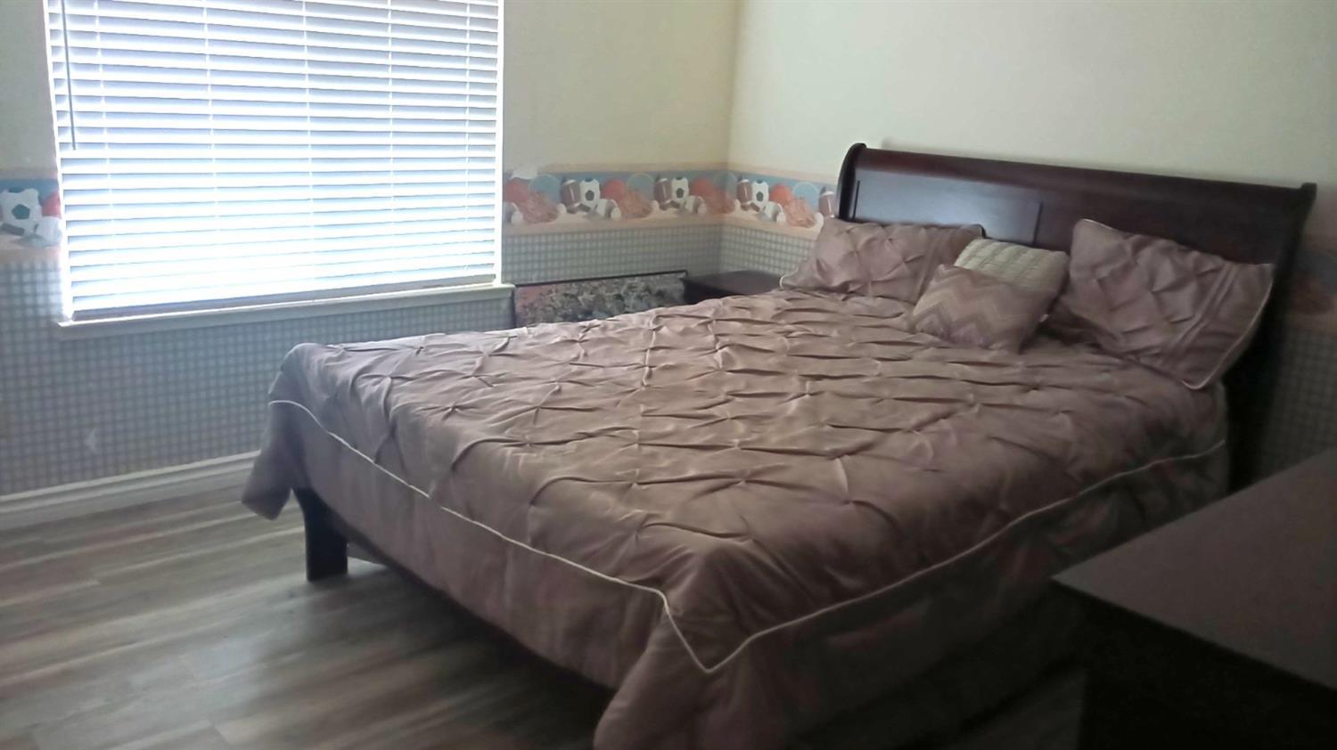 14728 Huntington Road Madera, CA 93636 - Photo 33 of 37 a bedroom with a bed and a window