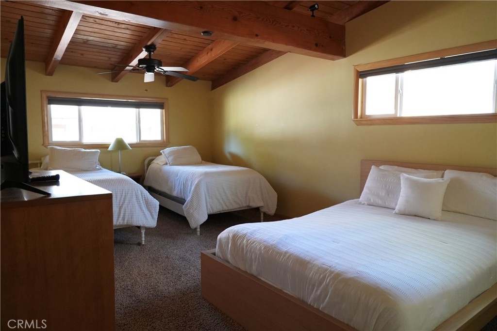 42958 Moonridge Road Big Bear Lake, CA 92315 - Photo 13 of 19 a bedroom with two beds and a chandelier