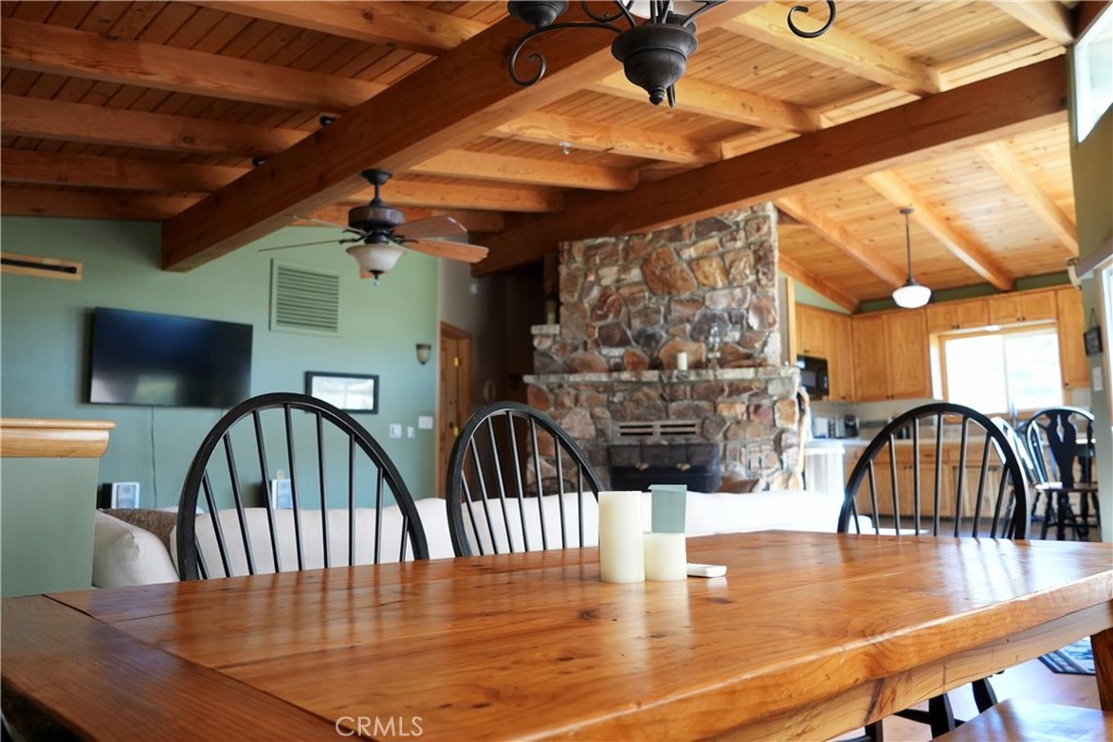 42958 Moonridge Road Big Bear Lake, CA 92315 - Photo 2 of 19 a dining room with wooden floor windows and a table