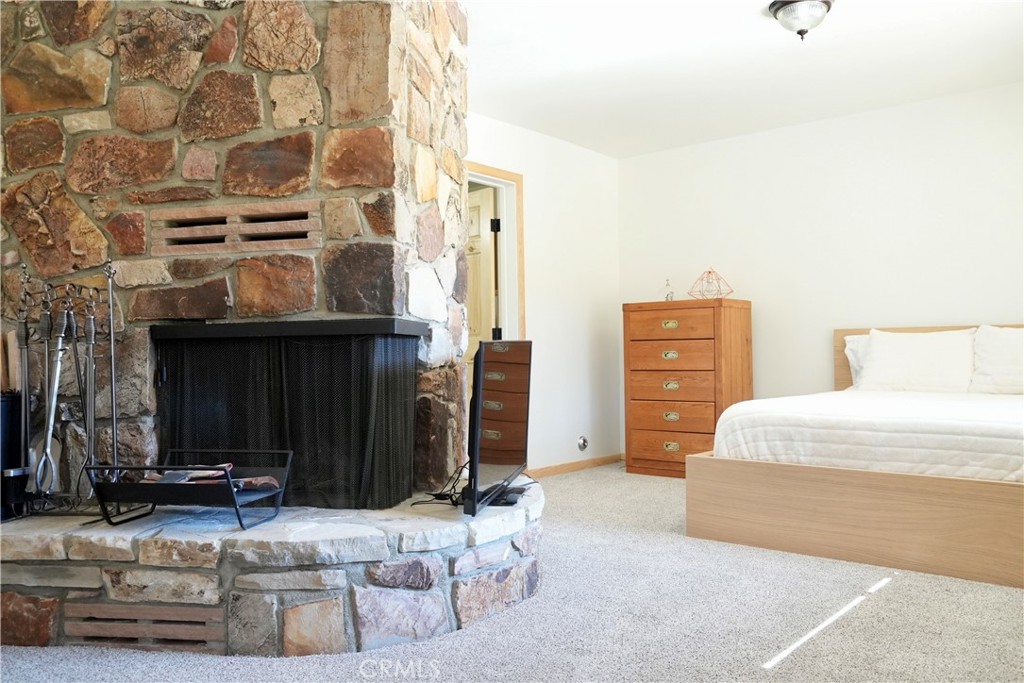 42958 Moonridge Road Big Bear Lake, CA 92315 - Photo 9 of 19 a living room with furniture and a fireplace