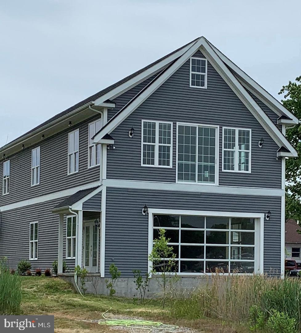 21572 Chicken Point Road Tilghman, MD 21671 - Photo 1 of 13 a front view of a house with a yard