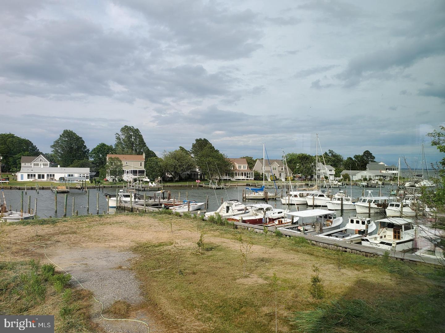 21572 Chicken Point Road Tilghman, MD 21671 - Photo 13 of 13 a view of a lake with boats and trees in the background