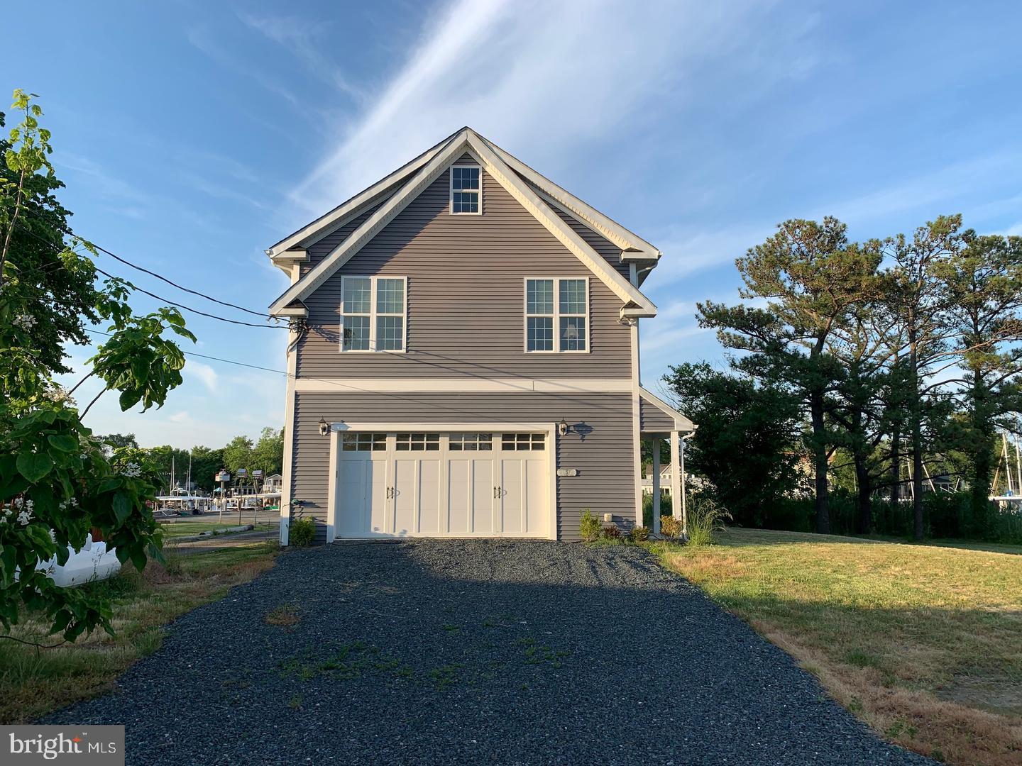21572 Chicken Point Road Tilghman, MD 21671 - Photo 2 of 13 a front view of a house with a yard